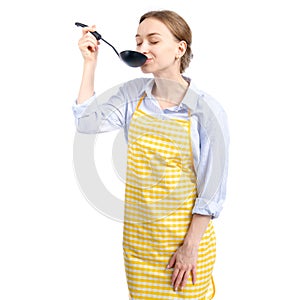 Woman in yellow apron with kitchen scoop in hand