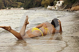 Woman in yellow bikini at beach