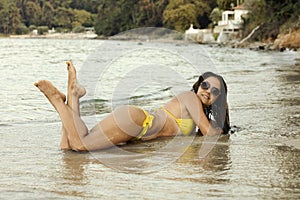 Woman in yellow bikini at beach