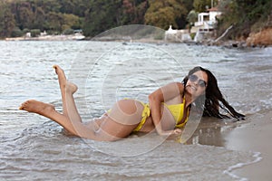 Woman in yellow bikini at beach