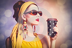 Woman in yellow clothes with coffee