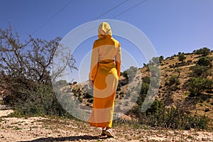 Woman in yellow djellaba.