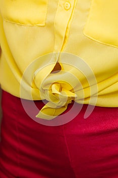 Woman in yellow knotted shirt closeup