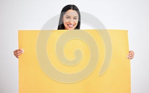 Woman with yellow mockup poster for advertising, marketing and product placement on blank cardboard. Happy, smile and a