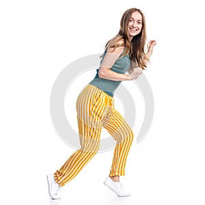 Woman in yellow pants smiling happiness goes sneaks sneak up