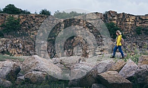 Woman in yellow raincoat hiking in the mountains