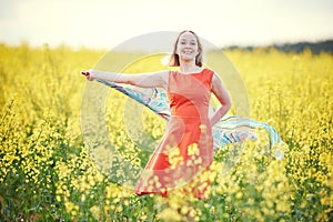 Woman at yellow seed meadow