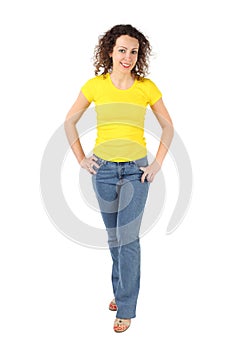 Woman in yellow shirt and jeans standing