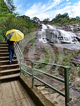 Woman yellow umbrella water montain