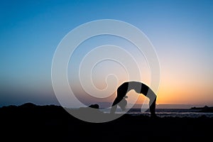 Woman and yoga bridge sunset silhouette
