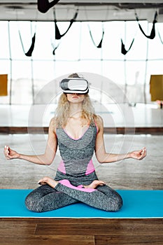 Woman in yoga class with VR headset