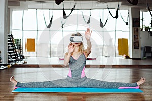 Woman in yoga class with VR headset