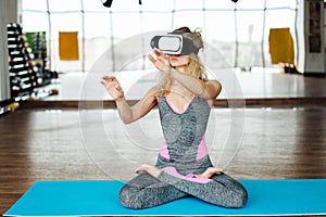 Woman in yoga class with VR headset