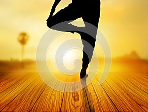 Woman yoga exercise in sunrise, soft and blur concept
