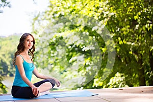 Woman on a yoga mat to relax.