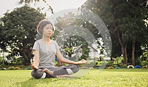 woman yoga and meditate in the lotus position at park