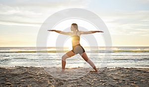 Woman, yoga and meditation on the beach for zen, spiritual wellness or workout in the sunset outdoors. Female yogi