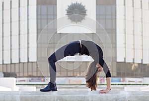 Woman in yoga pose in city