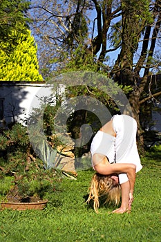 Woman in yoga pose in garden