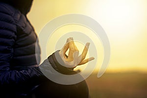 woman in a yoga pose at sunset - mindfulness, meditation, mental health