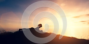 Woman in yoga pose, zen meditation at sunset