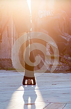 Woman in yoga position in city