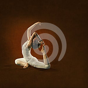 Woman in yoga position. Raja Kapota