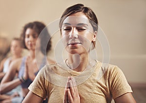 Woman, yoga and prayer hands with group for meditation, relax and zen for holistic and wellness. Female person