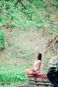 Woman Yoga, relax in nature. Forest summer