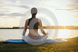Woman Yoga sitting  near river  nature sunset
