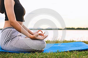 Woman Yoga sitting  near river  nature sunset