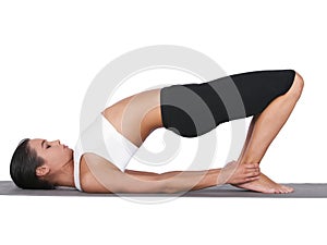 Woman, yoga and stretching body for pilates, exercise or training in workout on a white studio background. Calm female