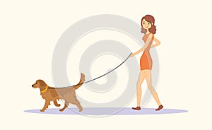 Woman or young girl in casual clothes walking the dog Golden retriever breed.