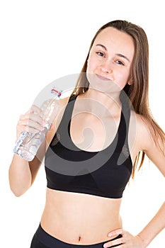 Woman young sport athlete takes a break drinking water bottle