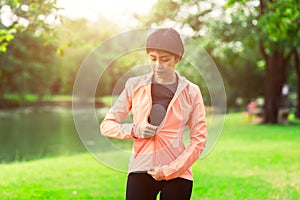 Woman zipping zip up before excercise