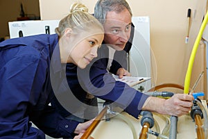 Womanas apprentice beeing tested by craftsman