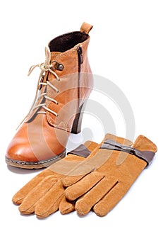 Womanly leather shoes and gloves on white background