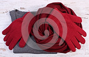 Womanly woolen clothes for winter on old wooden background