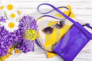 Womans accessories background with handbags, neckerchief, sunglasses and flowers. Summer womans outfits