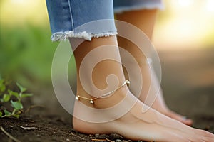 womans ankle with a dainty gold anklet