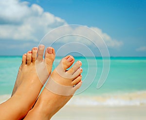 Womans Bare Feet over Sea background