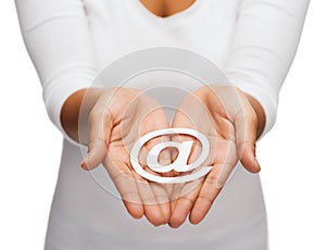 Womans cupped hands showing e-mail cutout sign