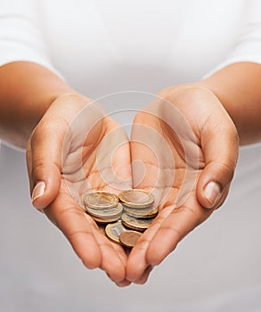 Womans cupped hands showing euro coins