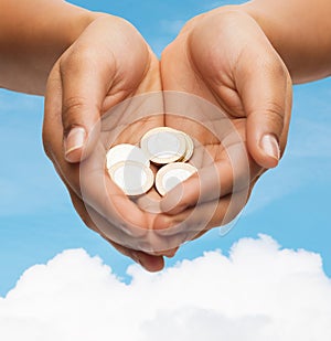 Womans cupped hands showing euro coins