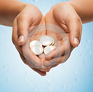 Womans cupped hands showing euro coins