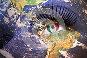 Womans face with planet Earth texture and mexican flag inside the eye