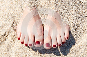 Womans feet in sand