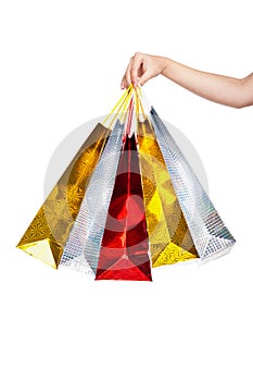 Womans hand holding colorful shopping bags