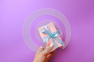 Womans hand holding Gift box on color background. Happy womens day. Happy Mothers day.Hello Spring- Image