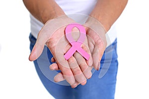 Womans hand holding pink breast cancer awareness ribbon